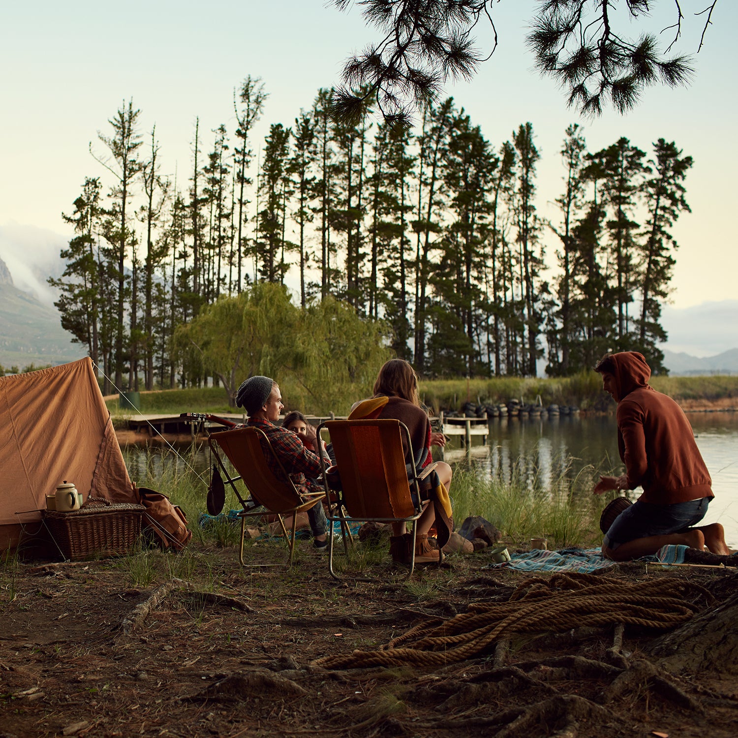 Young friends camping by lake