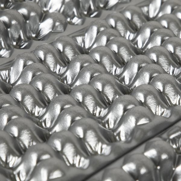 The bumps and divots on closed cell foam pads cut weight, and may allow sleeping bag insulation to retain some loft, even when it's underneath you.