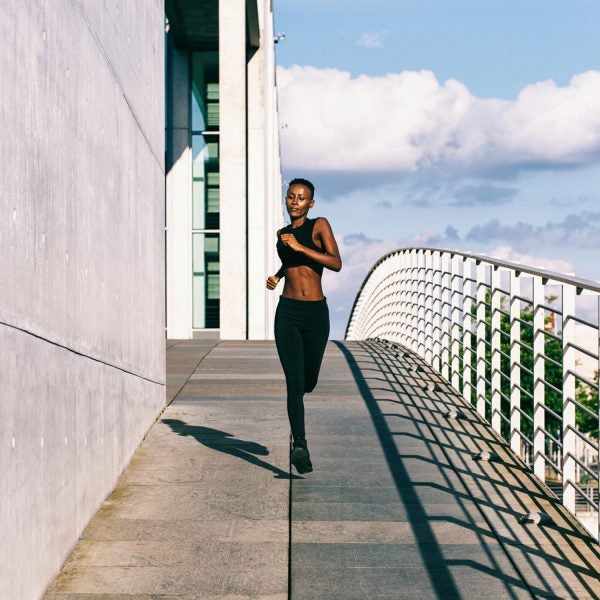 Young Fit African Woman Jogging In Urban Environment