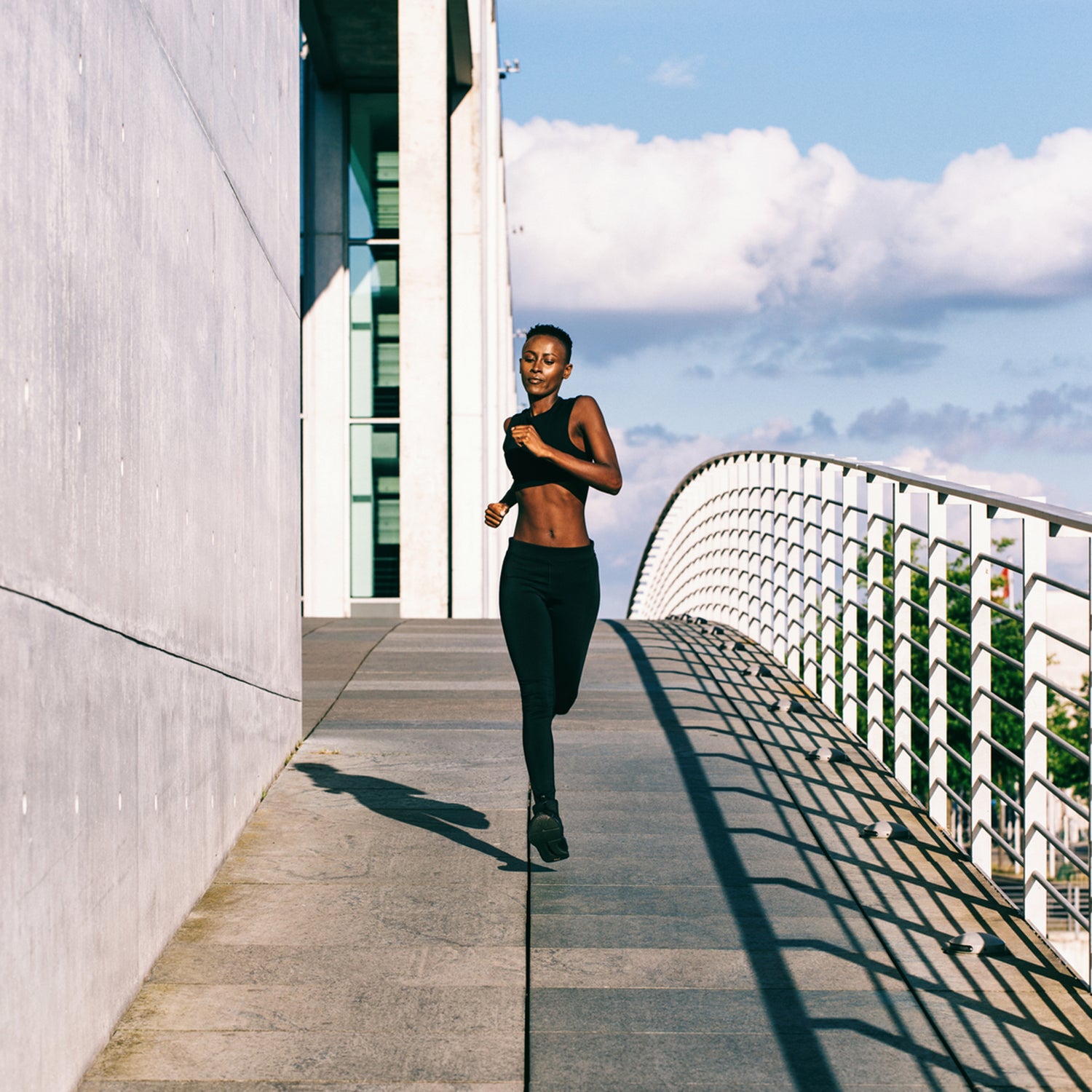 Young Fit African Woman Jogging In Urban Environment