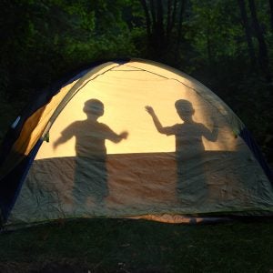 Children silhouetted in tent