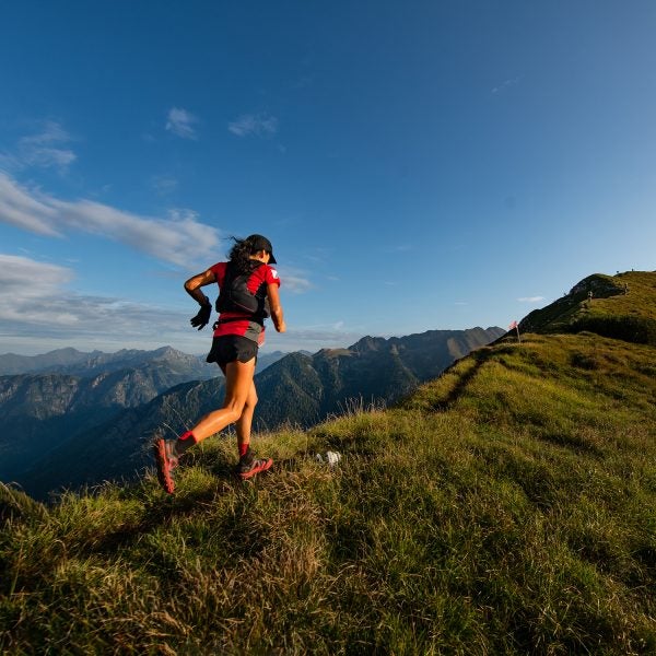 Sporty mountain woman rides in trail during endurance trail