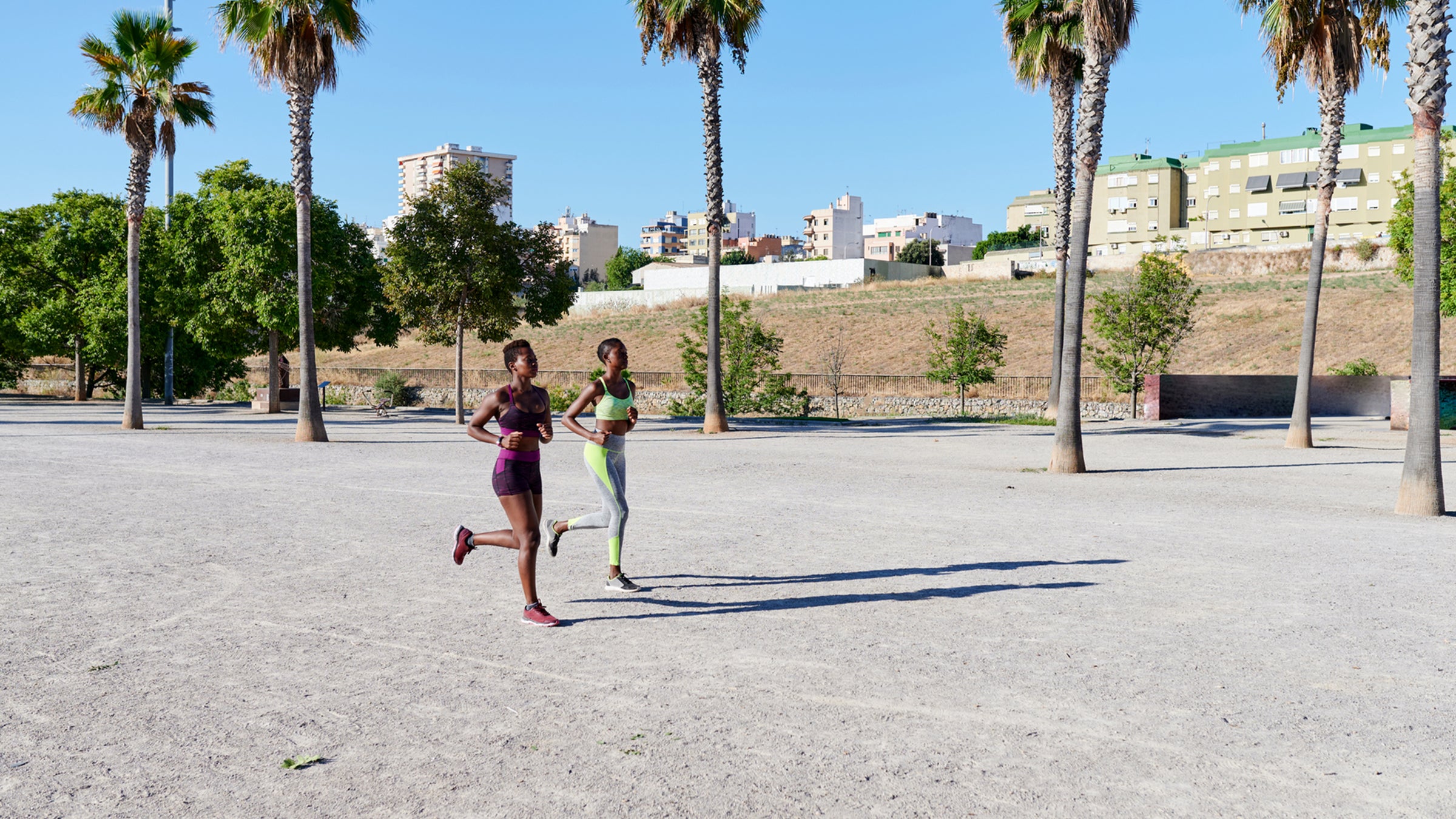 Two Women Jogging Through A Park
