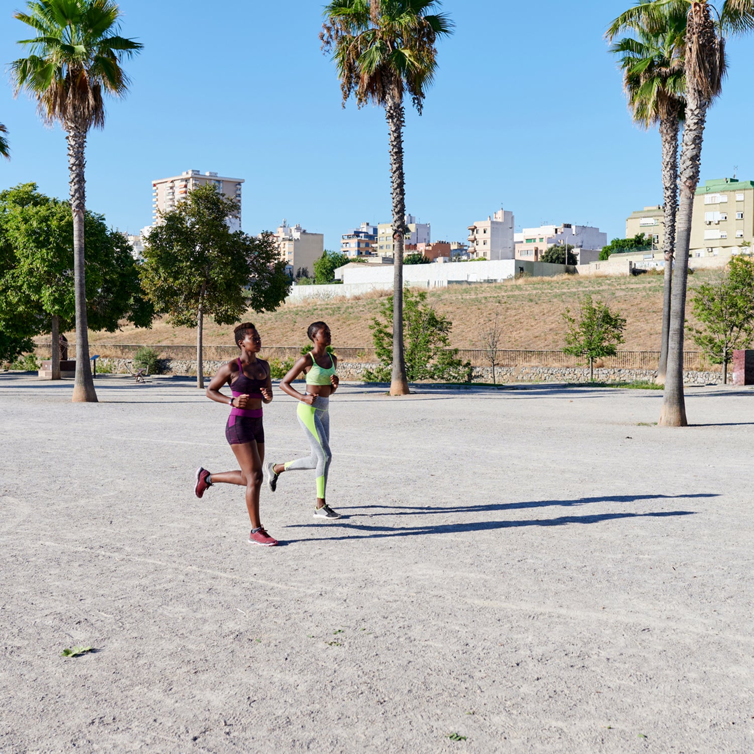 Two Women Jogging Through A Park