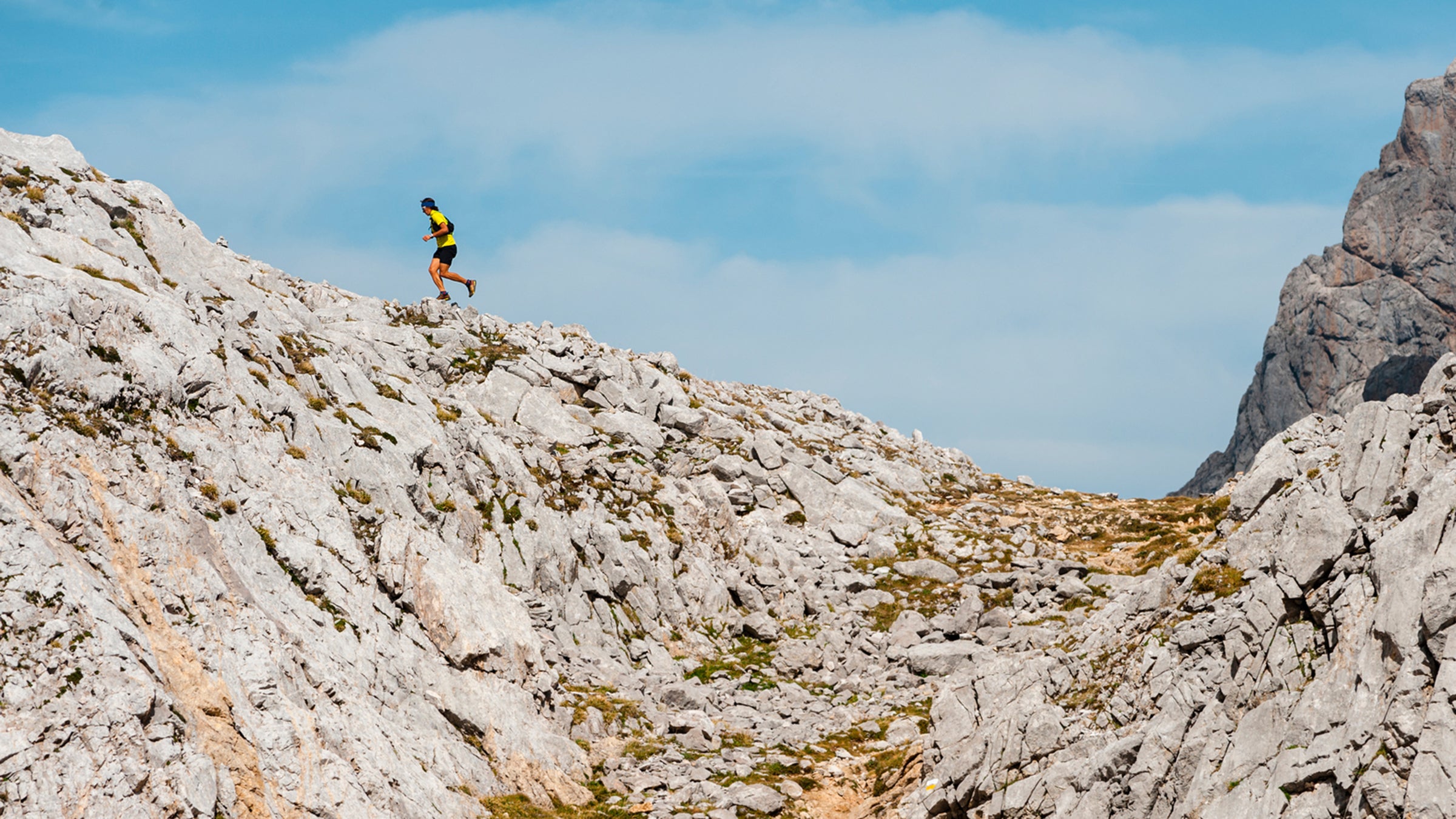 Runner Running Uphill Following Path In Mountain Landscape