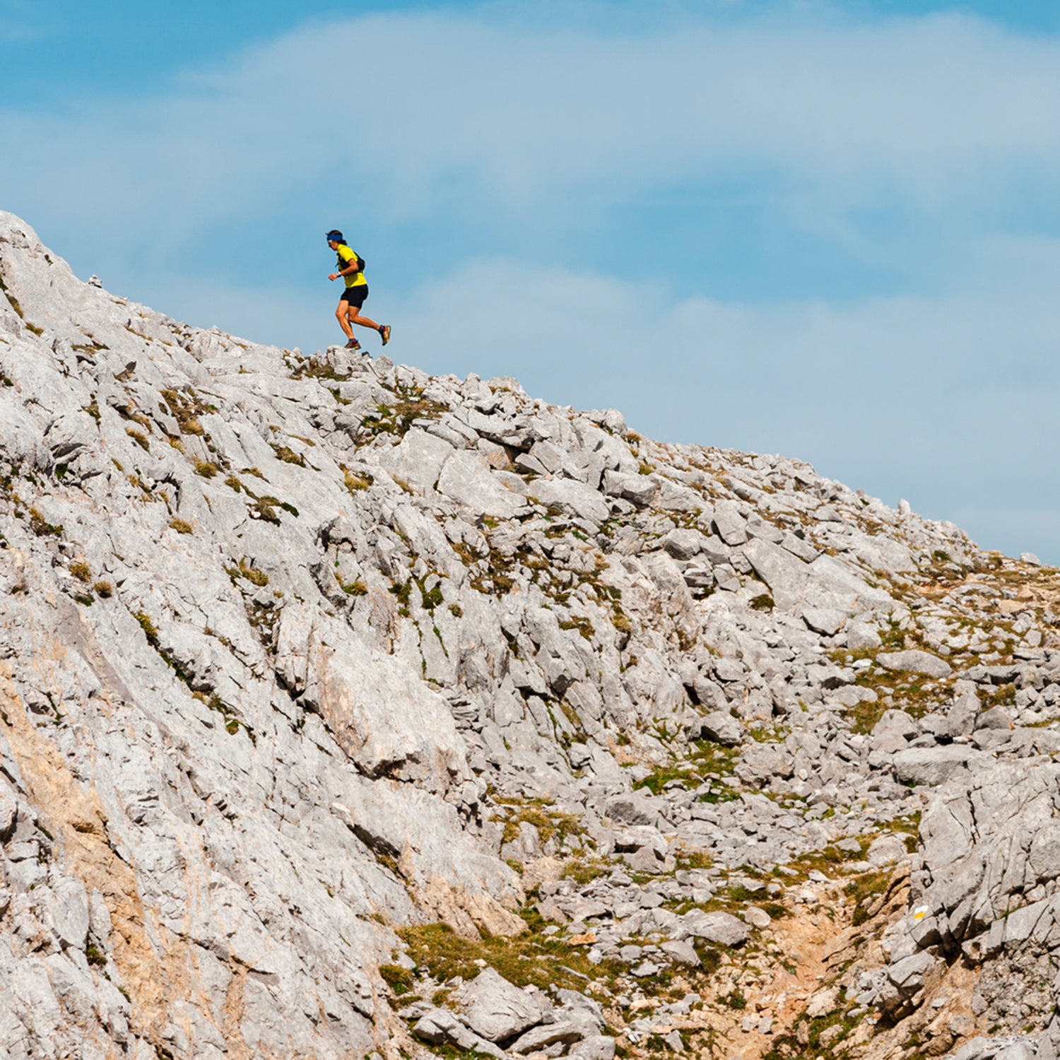 Runner Running Uphill Following Path In Mountain Landscape