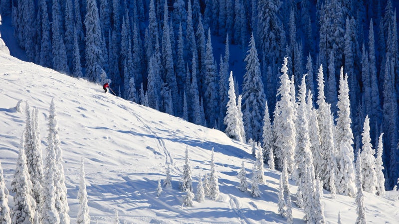 Skier On Snow Covered Mountainside
