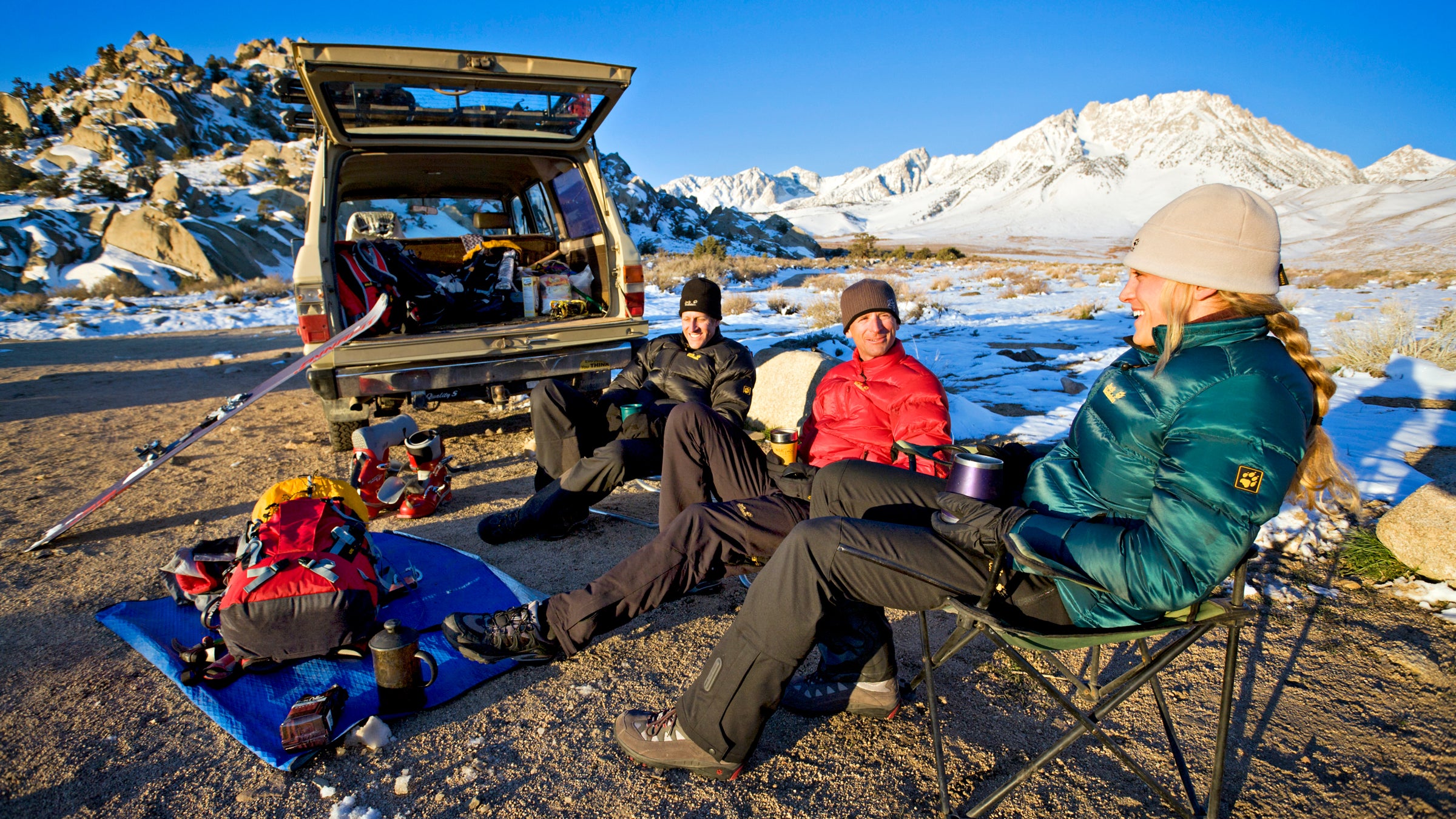 Friends relaxing while car camping