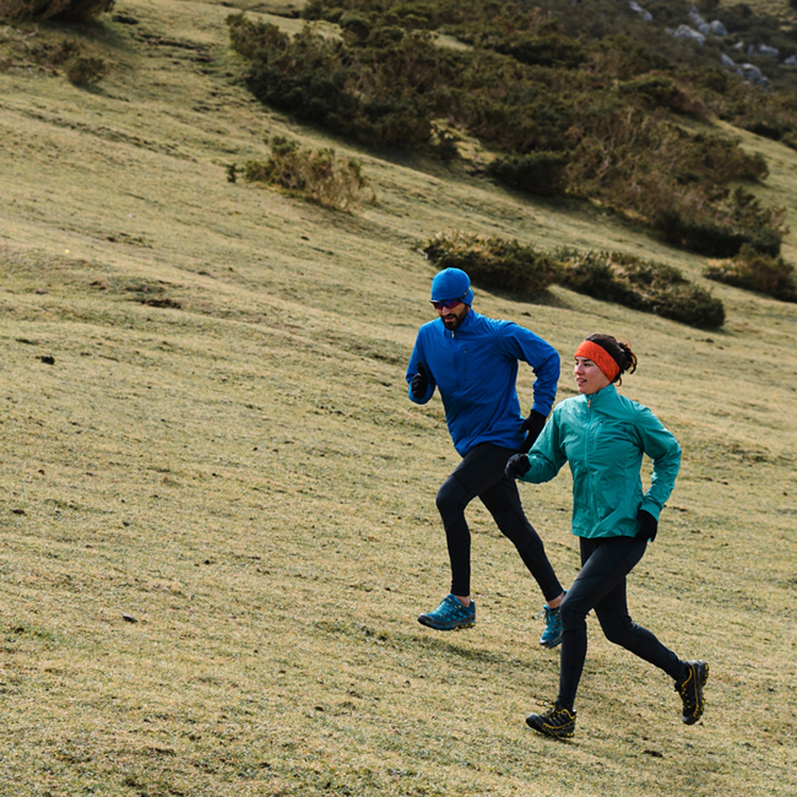 Multi Generational Friends Running Uphill In Mountain Scenery