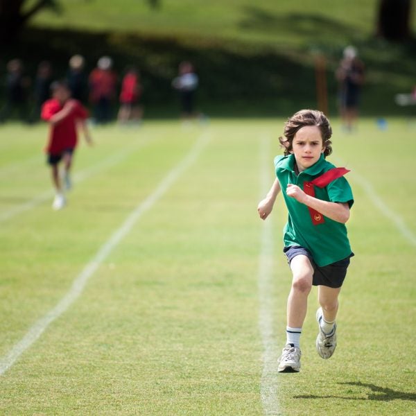 Child With A Determined Expression Winning A Running Race