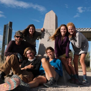 Clockwise from left: Vince, Monica, Aiden, Georgie, June, and Henry at Crazy Cook Monument after completing their southbound CDT hike