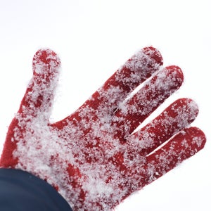 Glove buried in snow after avalanche .