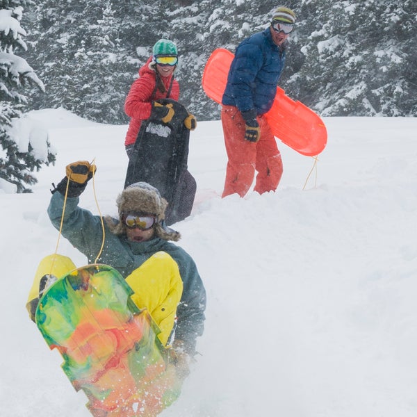 A group of adults sledding near Molas Pass outside of Silverton, Colorado.