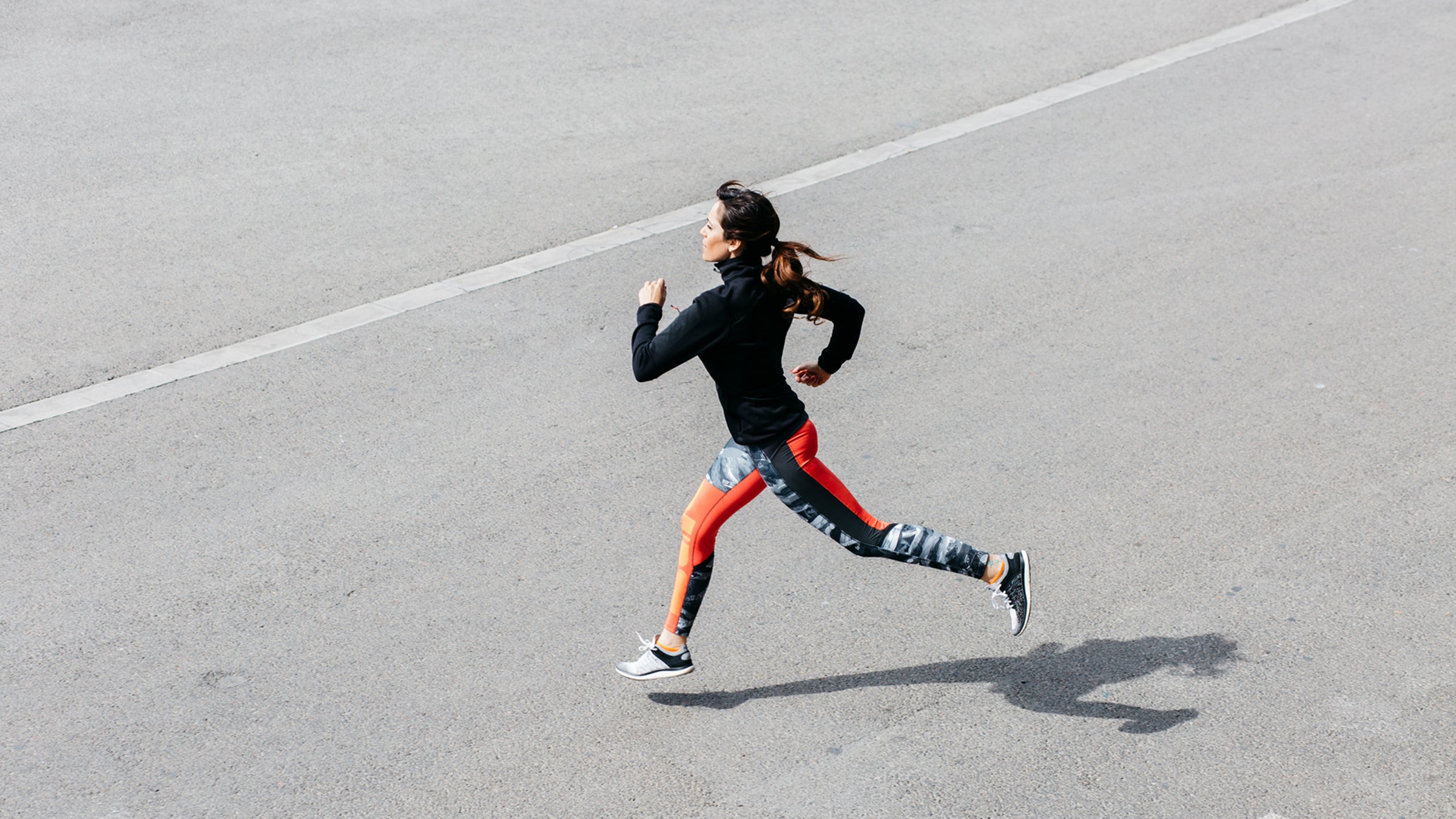 Side View Of Young Brunette Sportswoman Running