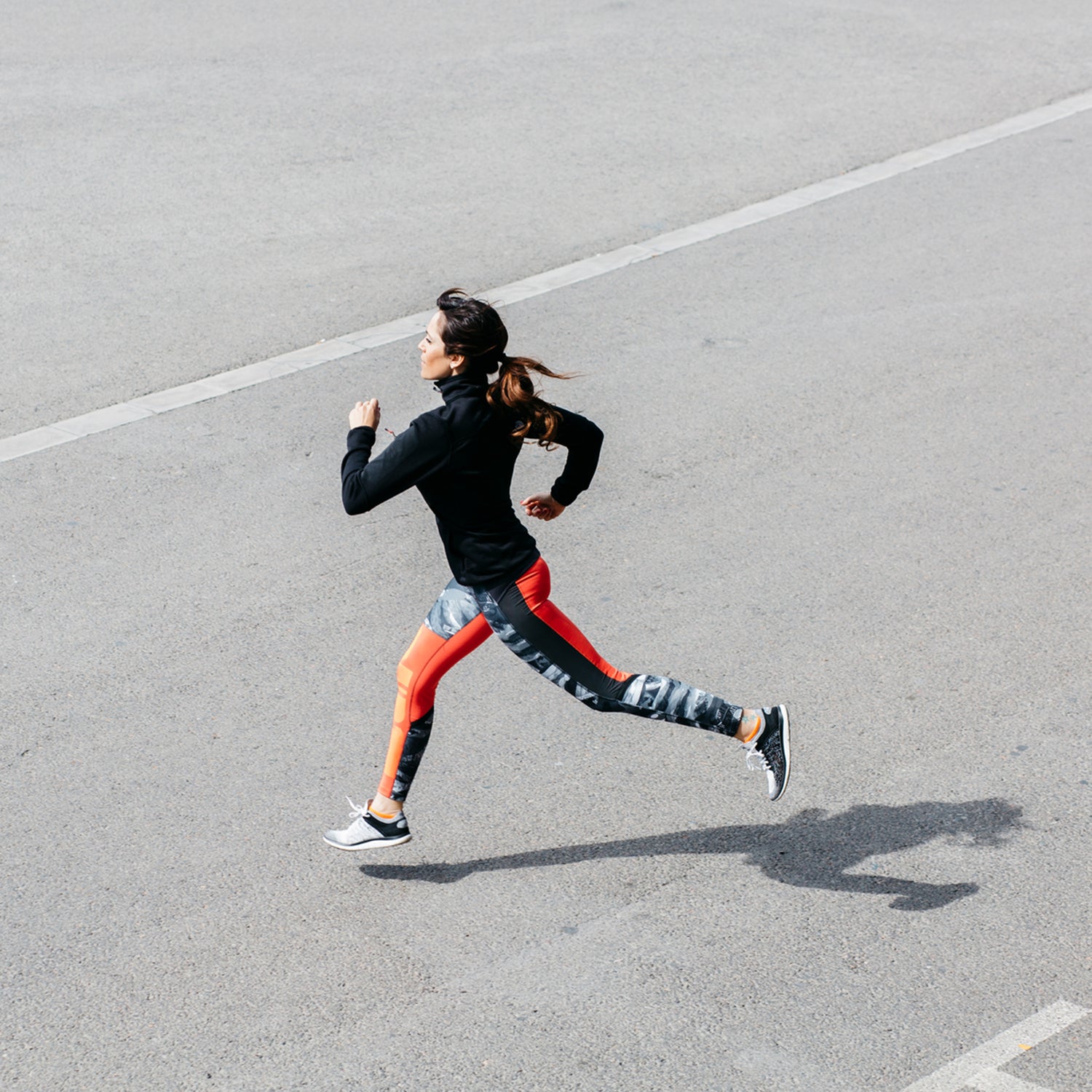 Side View Of Young Brunette Sportswoman Running