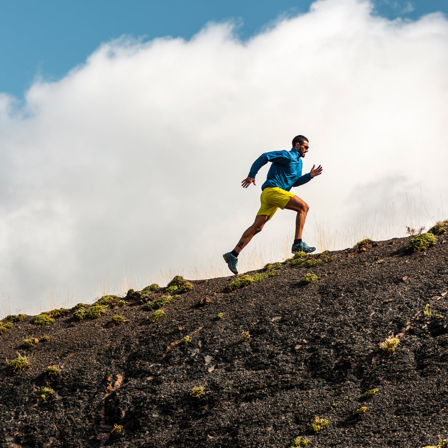Sportsman Running In Mountains On Foggy Day