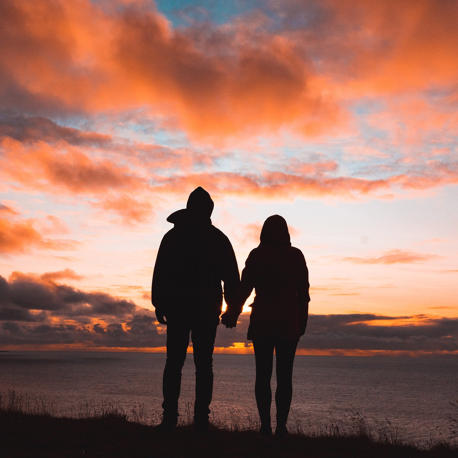 Couple silhouette by ocean