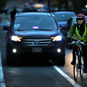 With a Lyft/Uber driver blocking the bike lane waiting for a passenger, a cyclist slows Beacon Street traffic in Brookline, MA