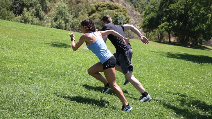 Man and woman performing hill sprints
