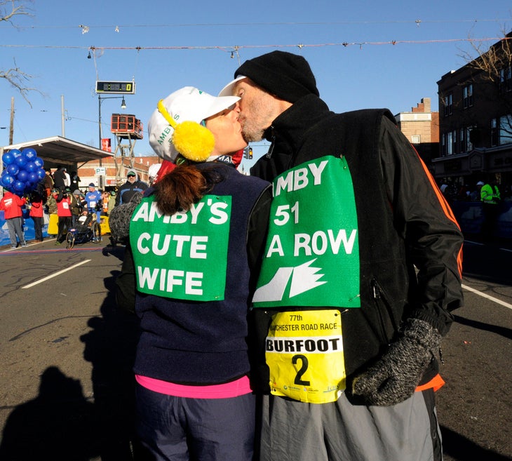 Amby Burfoot gets a kiss from his wife Cristina as he prepares for his 51 st Manchester Road Race in a row in 2013, setting the all time record.