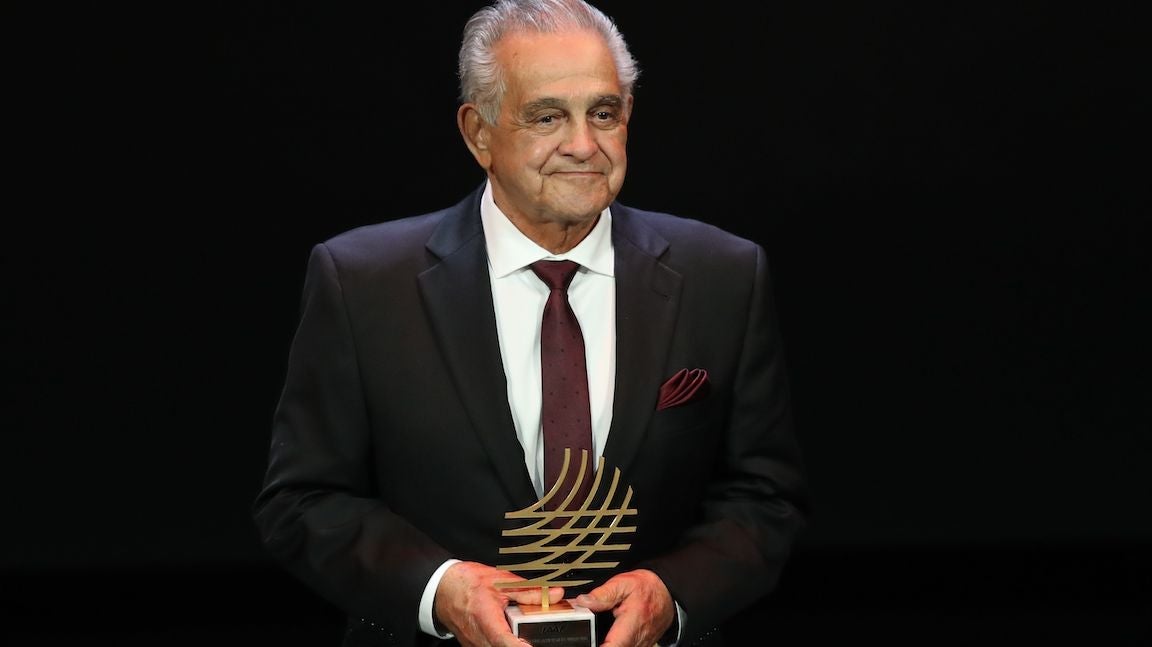 Joe Vigil with award in hand.