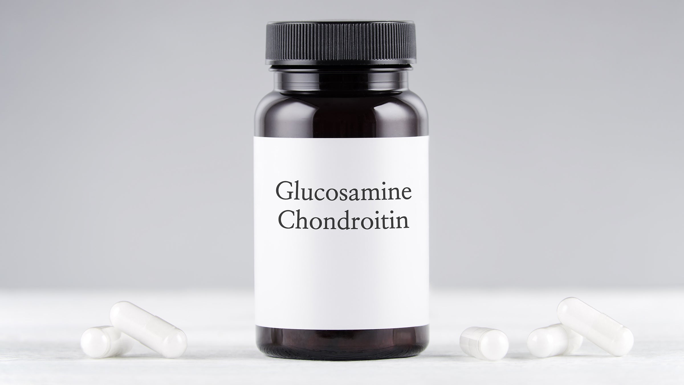nutritional supplement glucosamine and chondroitin bottle and capsules
