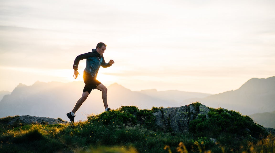 Runner running on a mountain at sunrise.