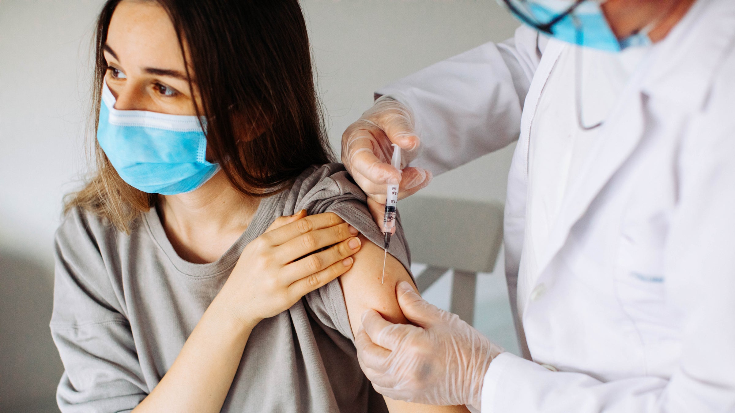 Closeup of a nervous woman and her doctor