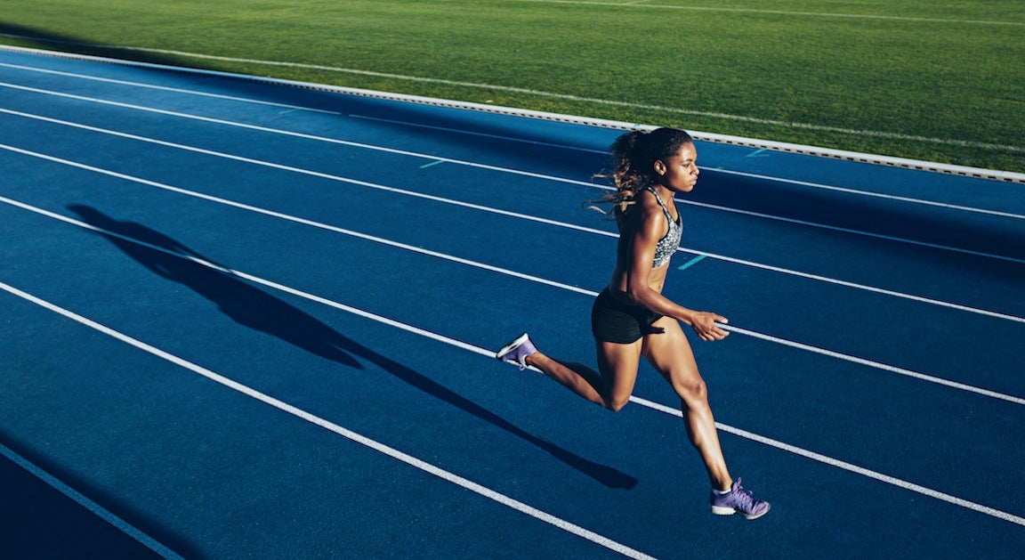Woman running on track