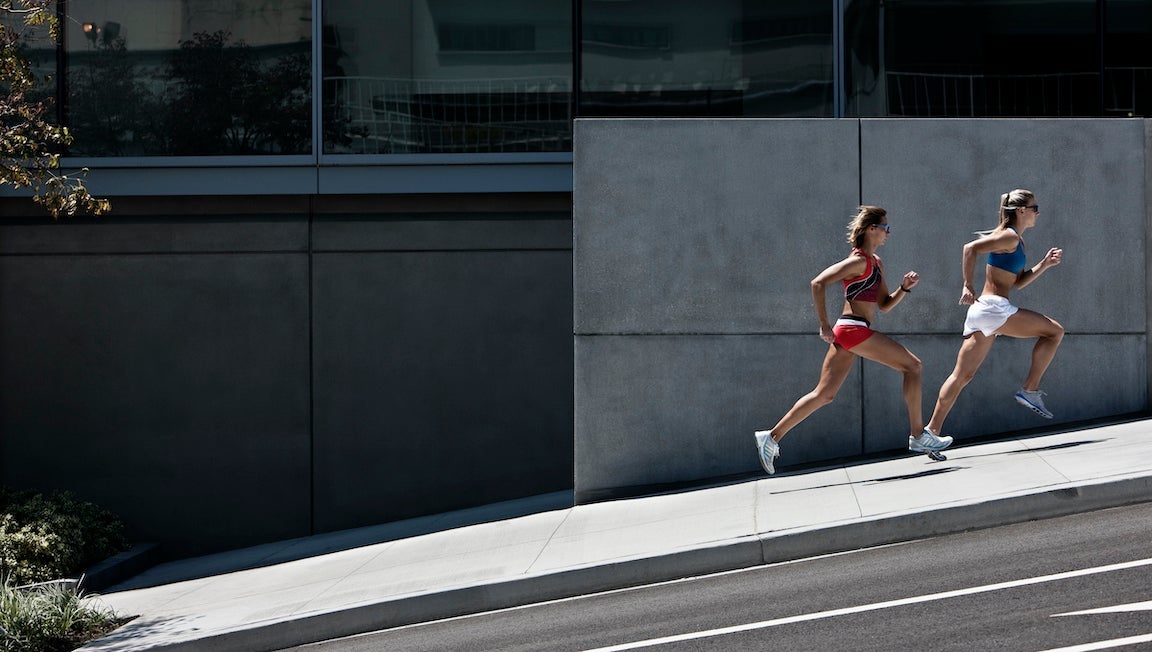 2 women running in the city.