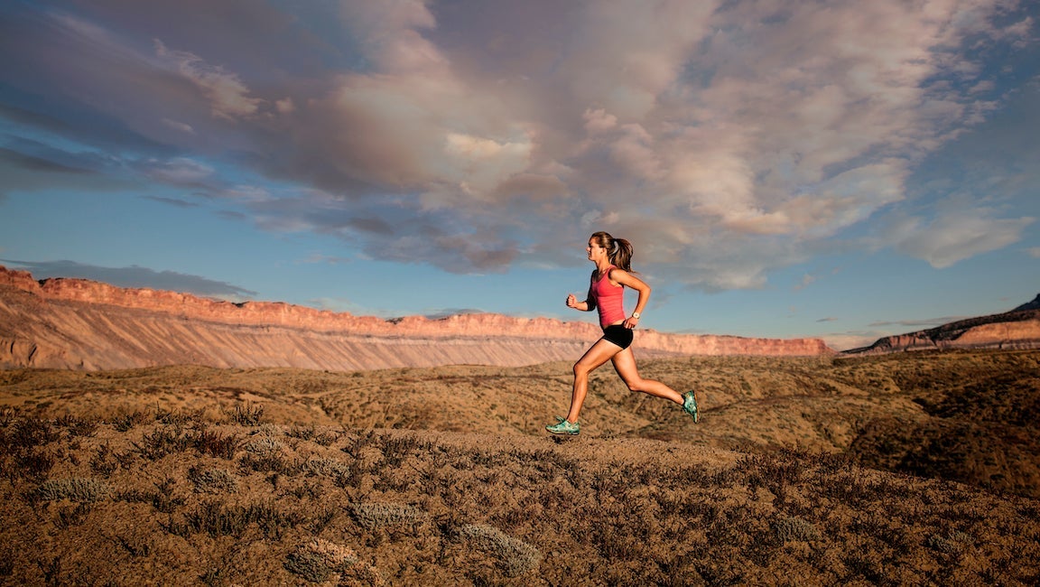 Woman trail running in desert, Grand Junction, Colorado, USA.