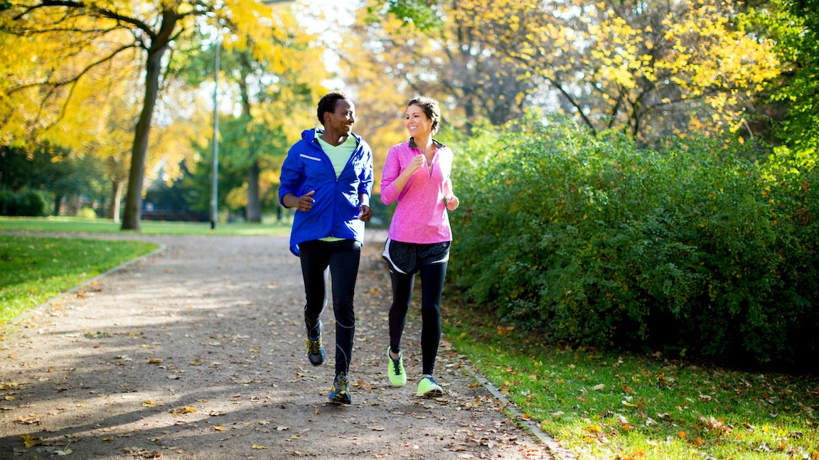Couple jogging in park.