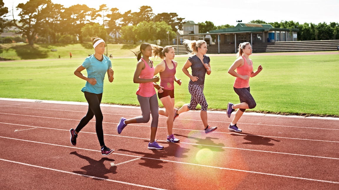 Shot of a group of young athletes out running on the track.