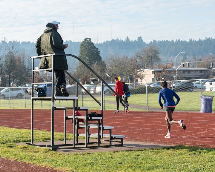Coach Mark Rowland timing Sally Kipyego