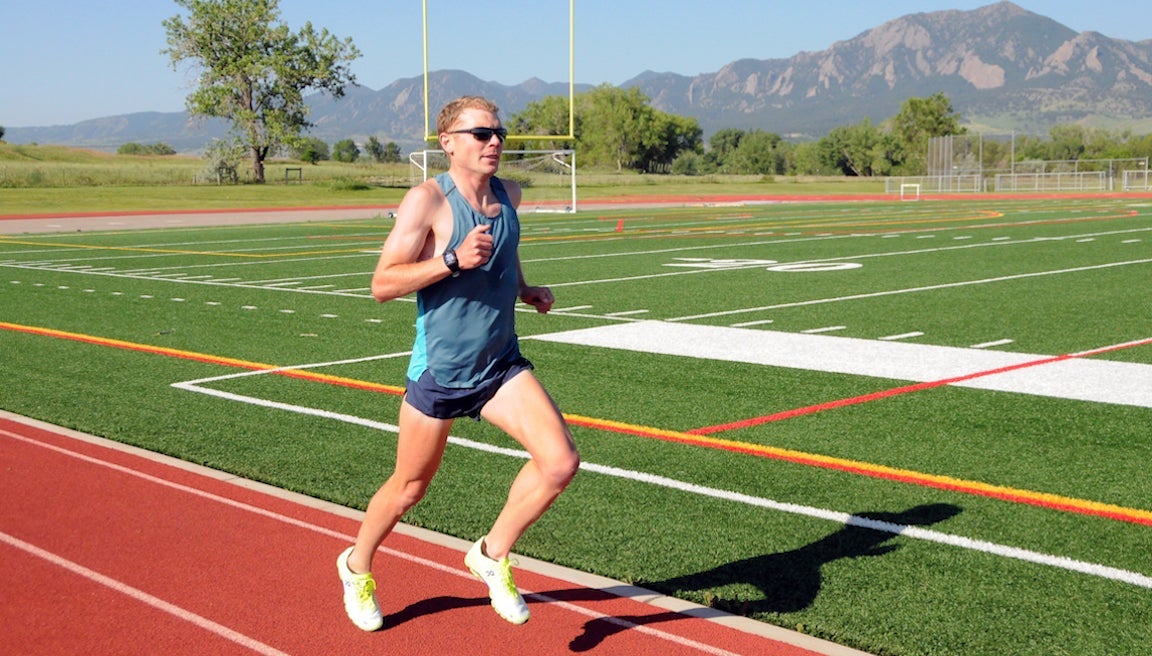 Jake Riley running on track in On shoes.