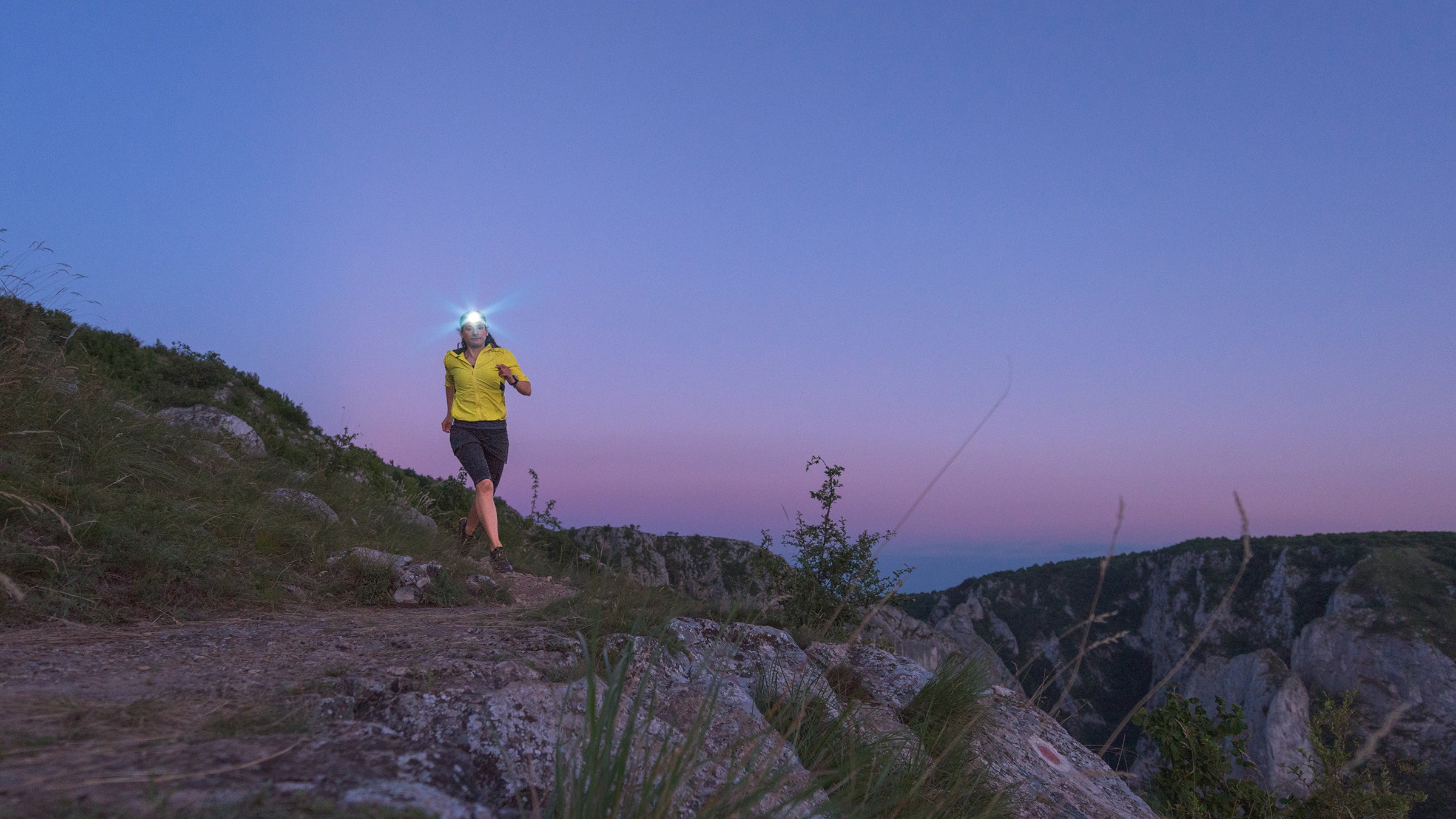 running on trail at night with headlamp