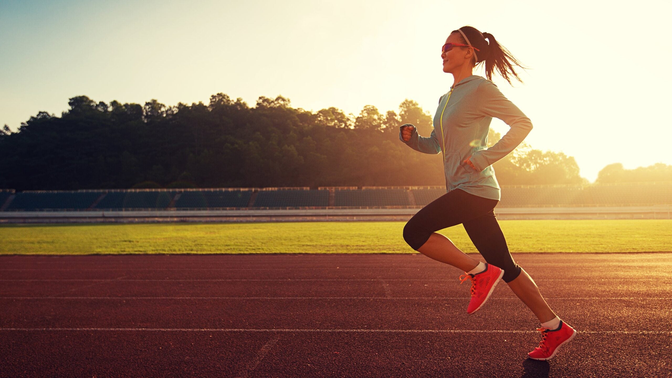 woman runner on track sunrise