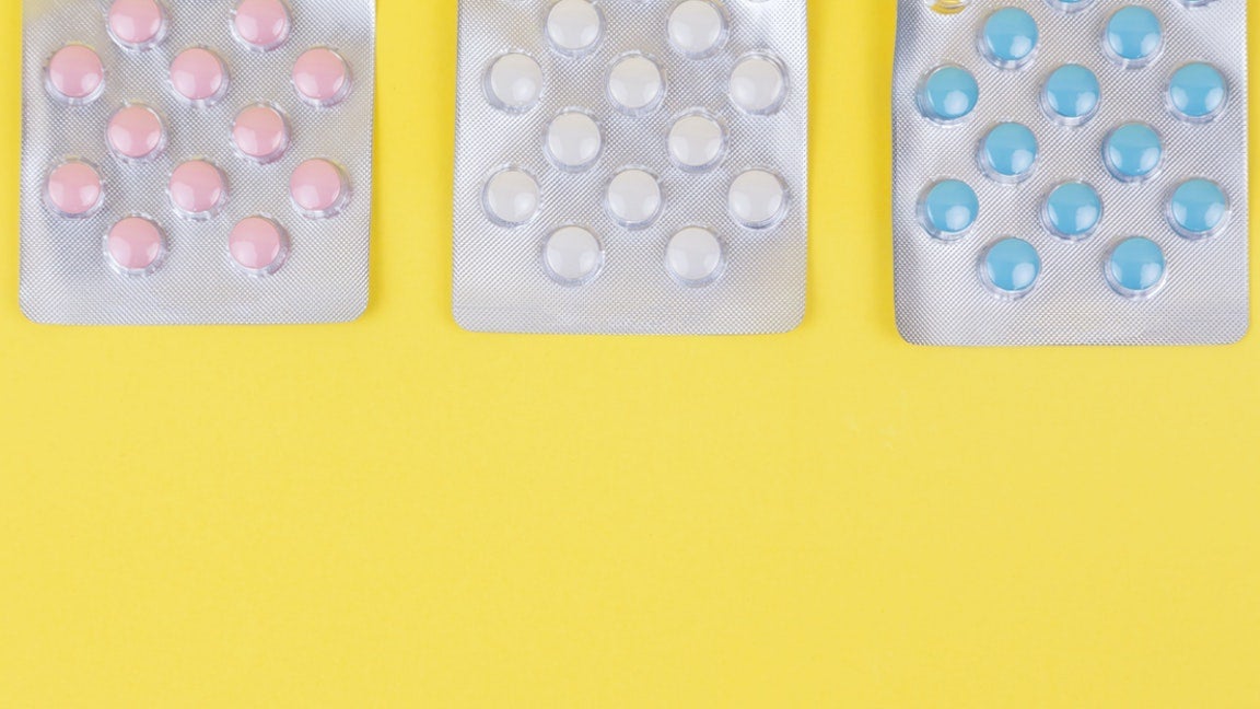 Pills against yellow background.