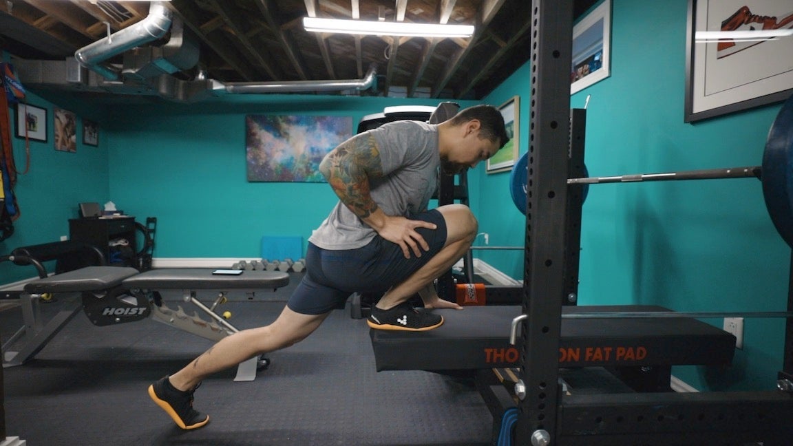 A guy in weight room doing a dorsi flexion exercise to treat an ankle sprain,