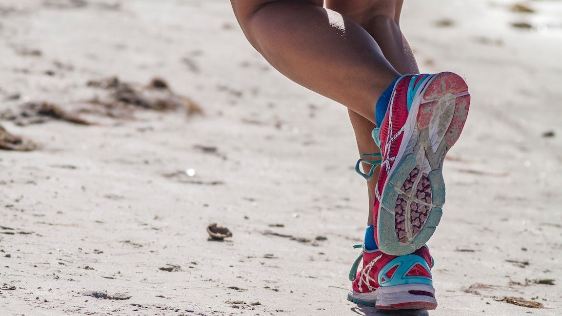 Person running, shows just the calves and feet (ASICs shoes).