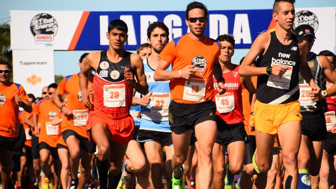 Runners racing in a road race in the summer.