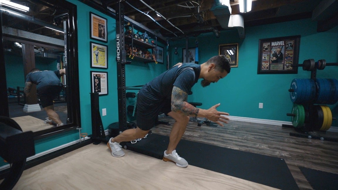 Man in gym doing strength exercises.