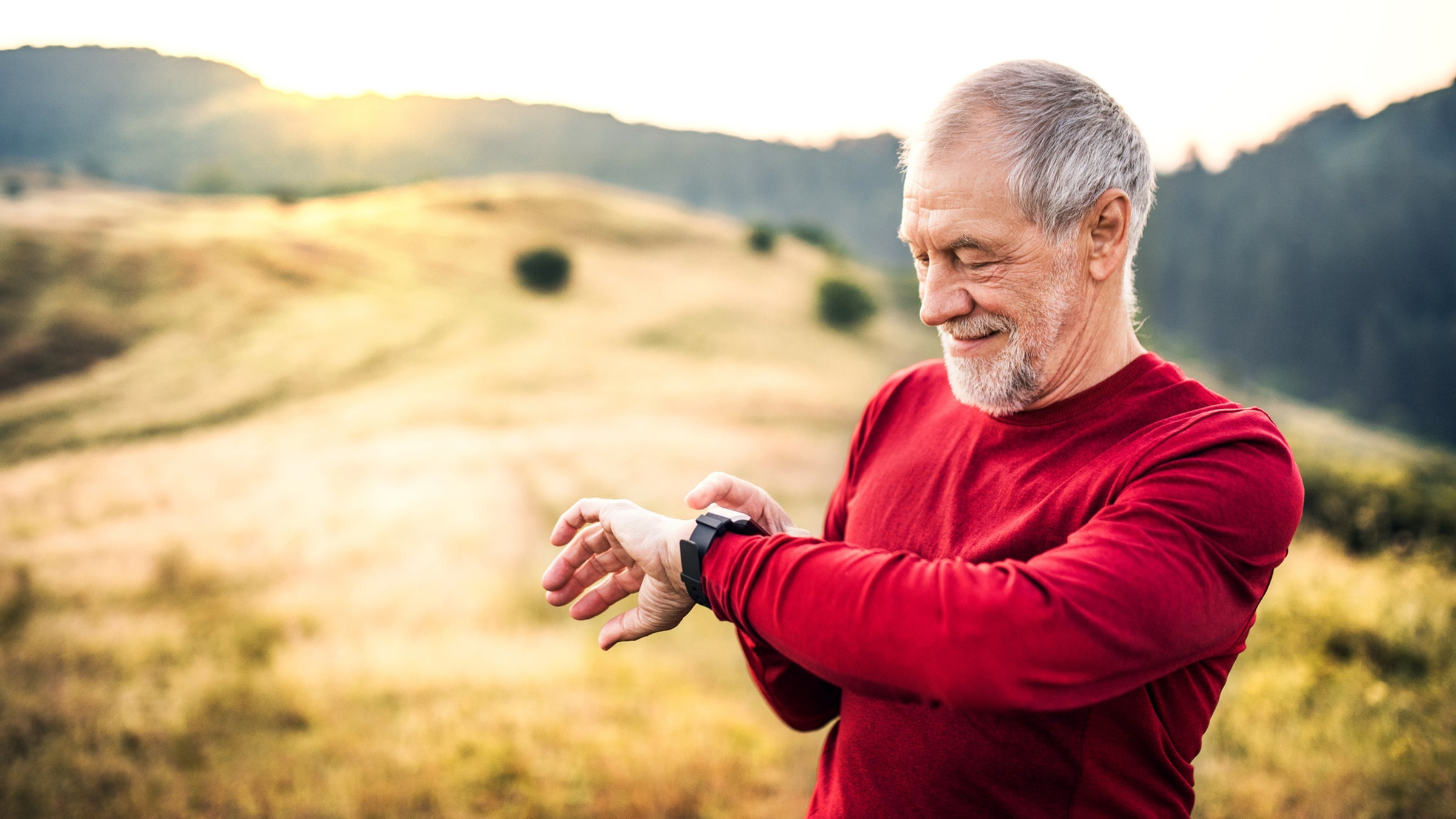 masters runner checking heart rate