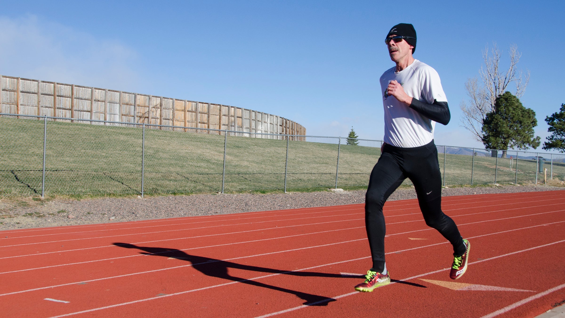 Masters age man running on track