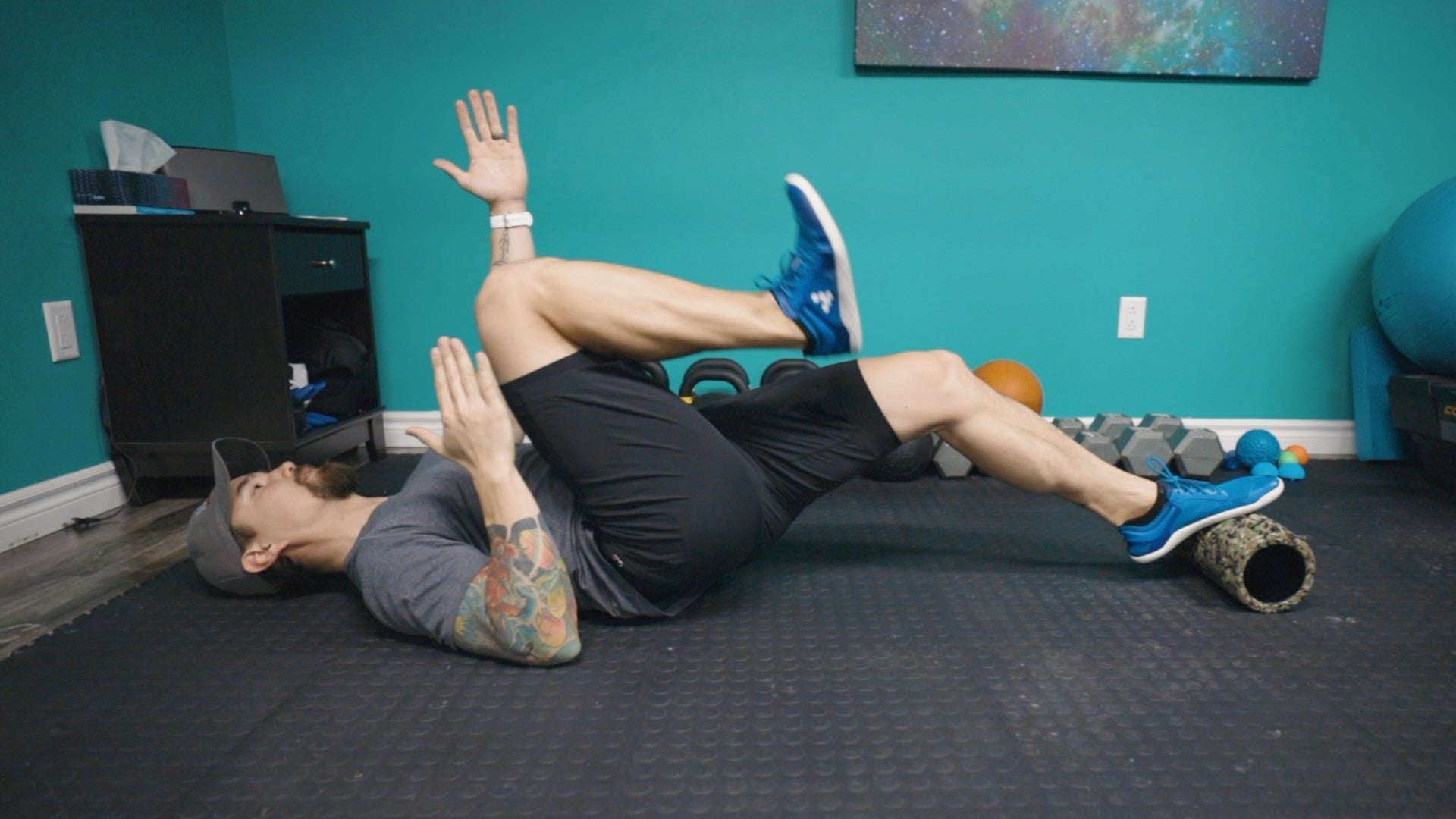 Man looking like he's in a running pose with one leg straight and one bent in with knee to chest, but laying with back on ground.