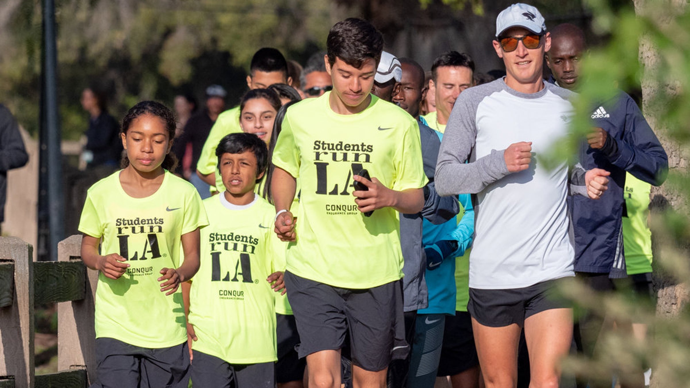 Students in SRLA shirts run with their teachers in the LA Marathon