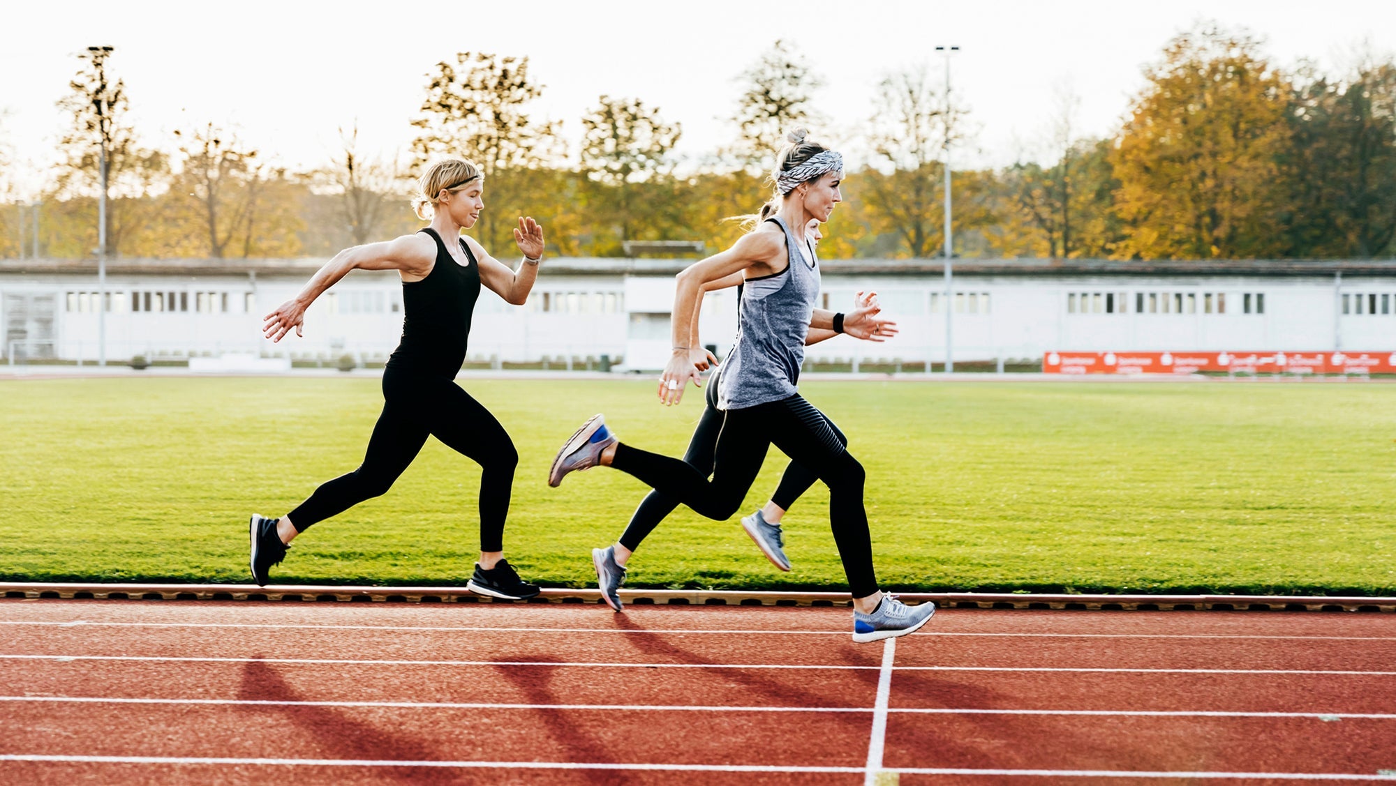 women running speed workout on track