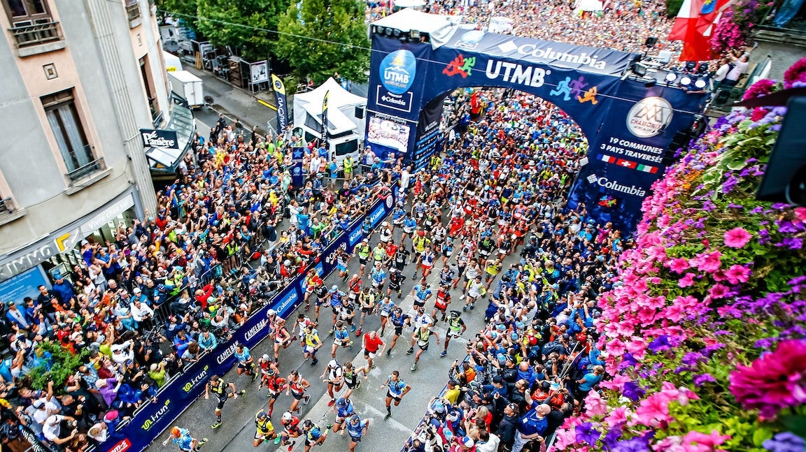 Aerial shot of a lot of runners on road at UTMB start line.