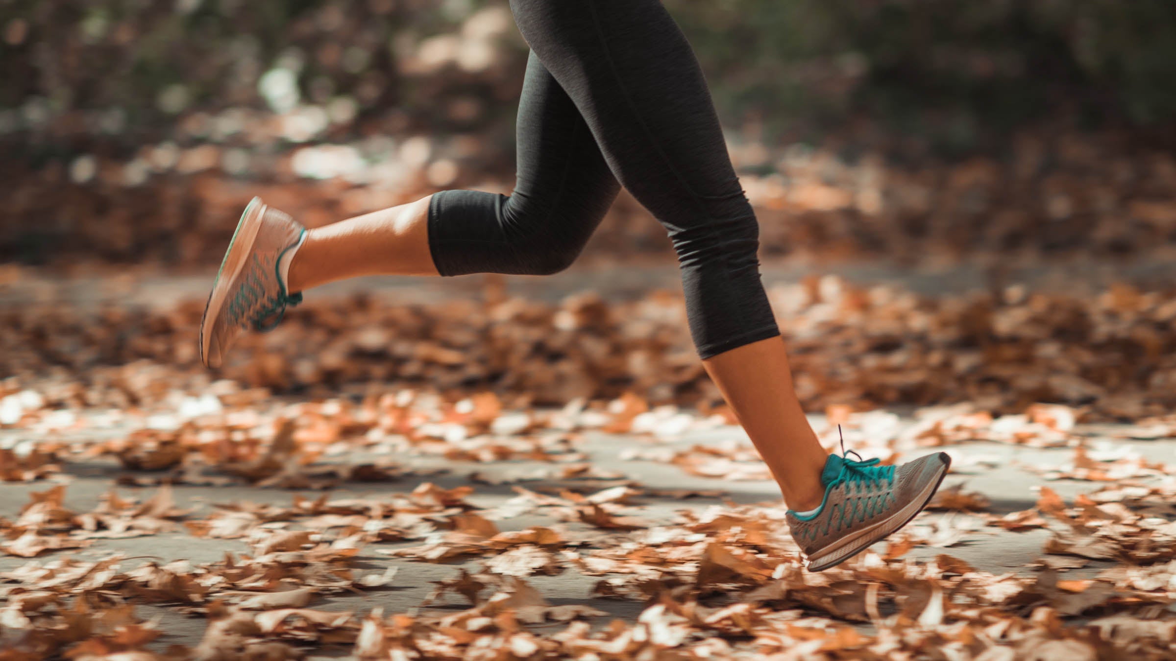 Woman Jogging Outdoors In Autumn