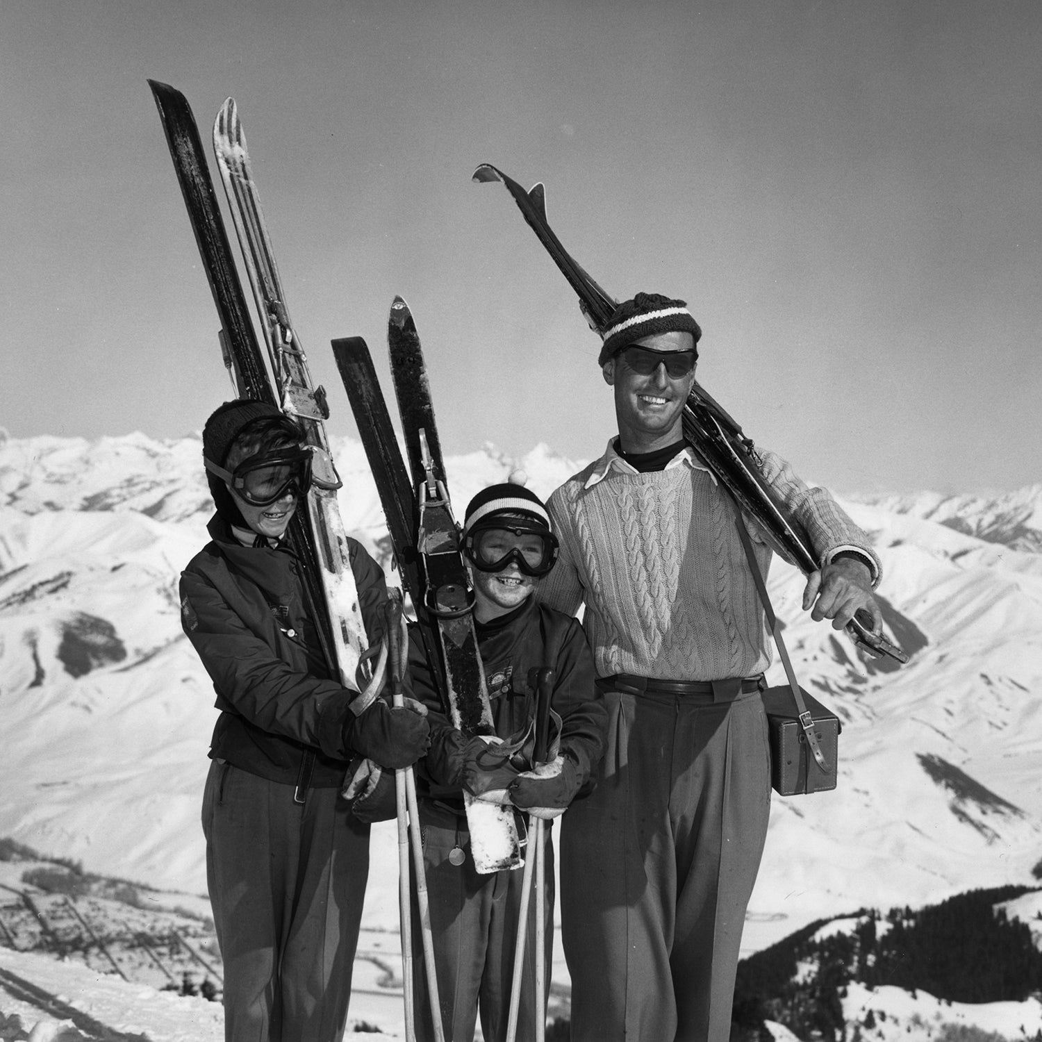 Vintage family carrying skis